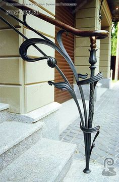 an iron handrail on the side of a building