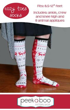 the legs and feet of a woman wearing socks with reindeers on them are shown