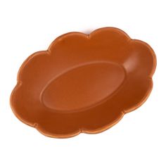 a brown plate with an oval shape on the top and bottom, sitting in front of a white background