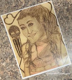 a drawing of a woman holding a microphone on top of a granite counter with the words i love you written above it