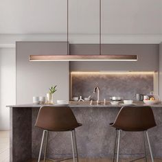 two bar stools sit in front of an island with marble countertops and built - in lighting