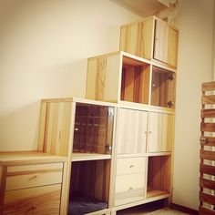 an empty room with wooden shelves and drawers