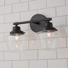 two light fixtures on a white brick wall