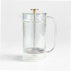 a glass coffee pot with a gold handle