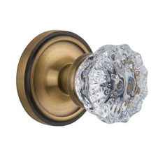 an antique brass door handle with crystal glass knob