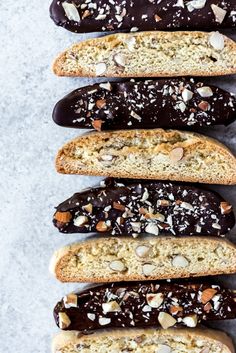 several slices of bread with nuts and chocolate spread on them, lined up in a row