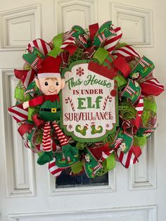 a christmas wreath with an elf saying on it