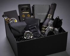 a black box filled with lots of different types of men's watches and accessories