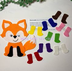 cut out felt animals and socks sitting on top of a table