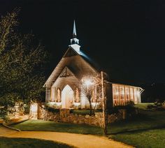 a church lit up at night with lights on