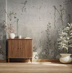 a room with flowers and plants in vases on the sideboard next to it