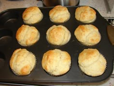 a pan filled with muffins sitting on top of a stove