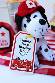 a stuffed dog with a sign that says thanks for a blazing good time