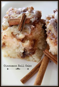 cinnamon roll cake on a plate with cinnamon sticks