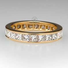 a yellow gold wedding band with princess cut diamonds