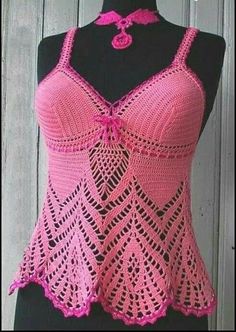 a pink crocheted tank top on a mannequin