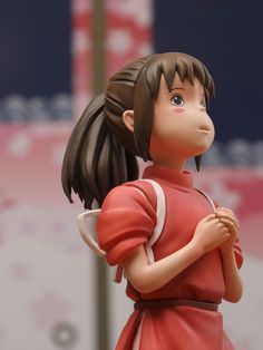 a close up of a figurine of a girl with an umbrella in her hand