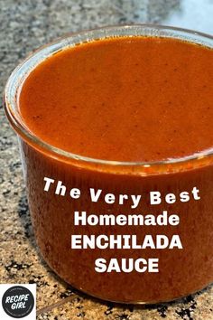 the very best homemade enchilada sauce in a glass container on a granite countertop