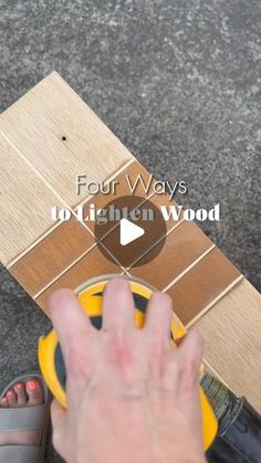 a person's hand on a yellow object with the words four ways to lighten wood