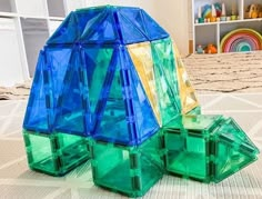 three plastic blocks sitting on top of a bed