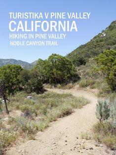 a dirt path with trees and bushes on the side, in front of mountains that reads turisita v pine valley california hiking in pine valley noble canyon