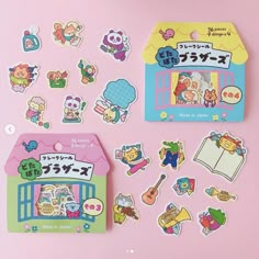 various stickers and magnets on a pink surface