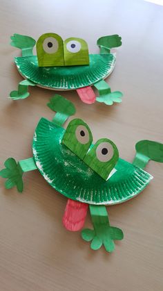 two paper plates that have some kind of frog on them