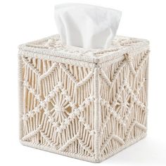 a tissue dispenser that is made out of rope and has a white napkin in it