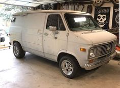 an old van is parked in a garage