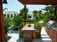 an outdoor kitchen and dining area is shown