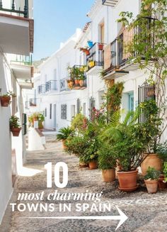 an alleyway with potted plants and the words 10 most charming towns in spain