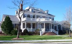 a large white house sitting on the side of a road