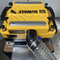 a machine that is sitting on top of a metal table with a water bottle in front of it