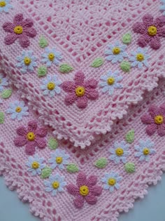 two crocheted baby blankets with flowers on them