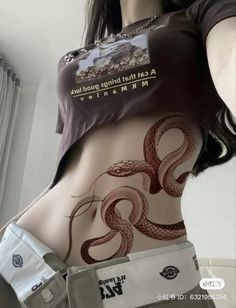 a woman with an interesting tattoo on her stomach