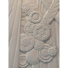 an intricately designed wall panel in white with circles and flowers on the top part