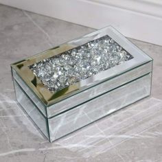 a glass box with some diamonds in it sitting on the floor next to a door