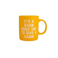 a yellow coffee mug that says it's a damn good day to give a damn