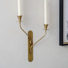 Inspired by a double wall sconce in Jos home, our Margo Antique Brass Double Wall Sconce is a modern take on classic wall decor. Crafted from brass, this sconce adds a modern feel to any hallway or living room. Includes wall anchors and screws for hanging. Brass Wall Candle Holder, Brass Wall Candle Sconces, Small Wall Kitchen Decor, Wall Sconces Above Nightstand, Frame Tv Sconces, Brass Wall Lights Bedroom, Sconces Flanking Tv, Brass Sconces Living Room, Vintage Candle Wall Sconces