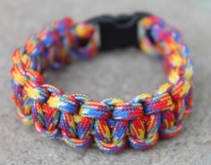 a multicolored bracelet is sitting on the ground