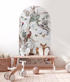 an animal themed wallpaper in a children's room with white walls and wooden flooring