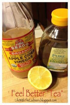 a bottle of apple cider vinegar next to a sliced lemon