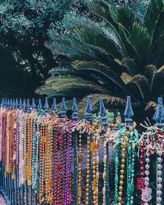 a fence covered in lots of beads and chains