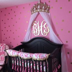 a baby's room decorated in pink and gold