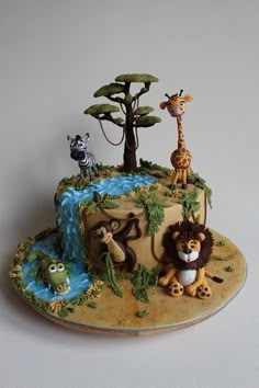 a cake with animals and trees on it