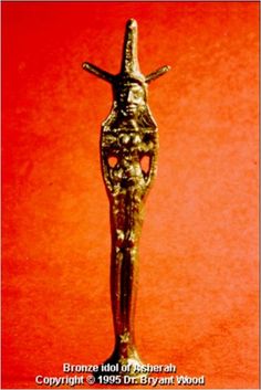 a gold colored statue is on display against a red background