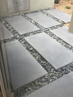 a patio with stones and gravel on the ground