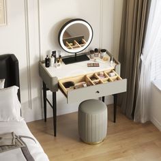 a bedroom with a vanity, mirror and stool next to a window in the room