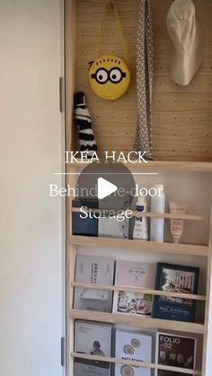 the inside of a bookcase with books and other items on it in front of a door