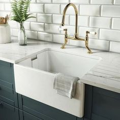 a white kitchen sink sitting under a faucet